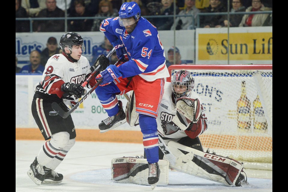 Givani Smith of the Kitchener Rangers jumps in front of Guelph Storm goaltender Anthony Popovich Sunday, March 25, 2018, at The Aud. Tony Saxon/GuelphToday