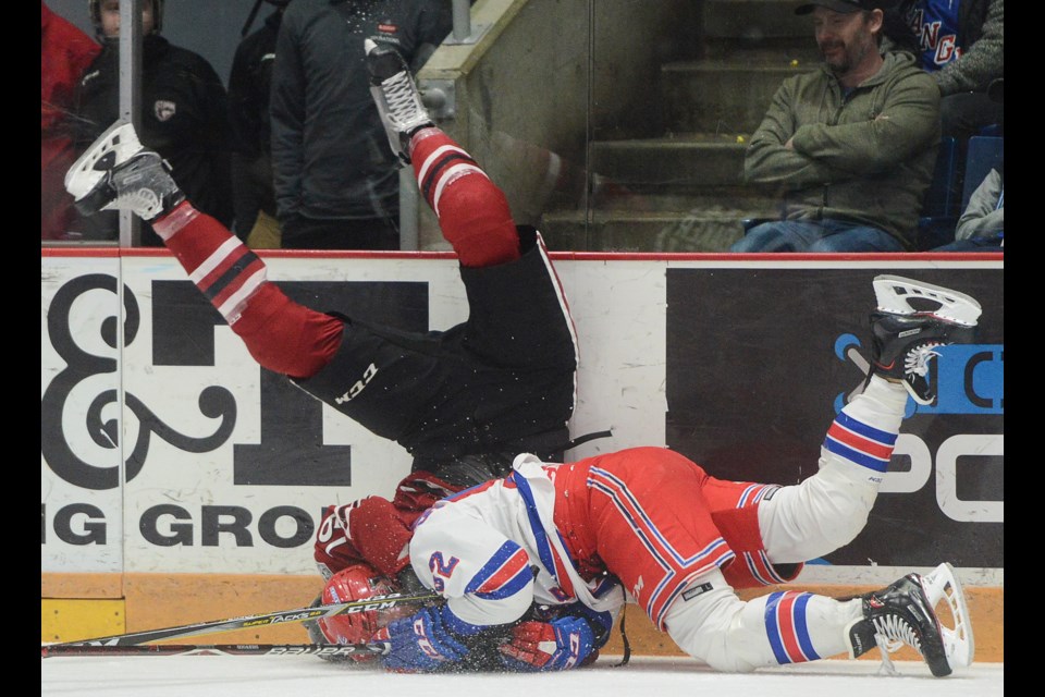 The Guelph Storm's Isaac Ratcliffe topples over Kitchener's Kole Sherwood Sunday, April 1, 2018, at the Sleeman Centre. Tony Saxon/GuelphToday