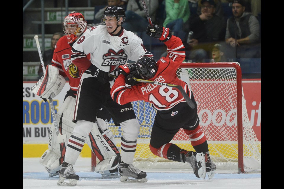 Isaac Ratcliffe dumps Markus Phillips in front of the Owen Sound net. Tony Saxon/GuelphToday