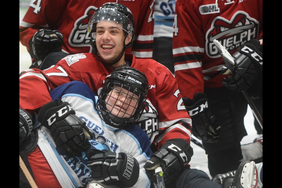 The Guelph Storm's Dom Commisso is all smiles while posing for post-game pics with members of the Guelph Giants hockey team Saturday at the Sleeman Centre. Tony Saxon/GuelphToday