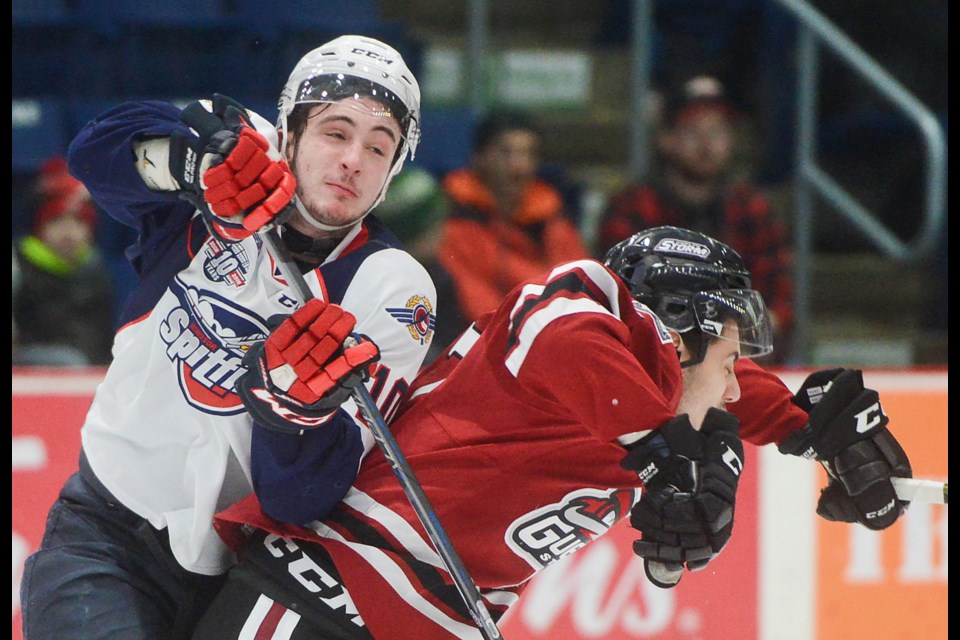 Dom Commisso of the Guelph Storm checks Jordan Frasca of the Windsor Spitfires Friday at the Sleeman Centre. Tony Saxon/GuelphToday