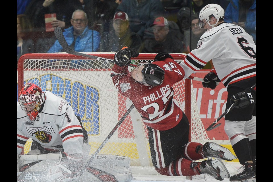 Guelph Storm defenceman Markus Phillips gets high sticked in front of the Owen Sound net Friday at the Sleeman Centre. Tony Saxon/GuelphToday