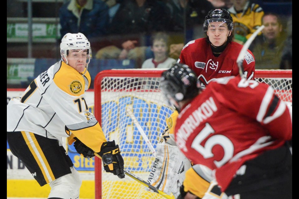 The Guelph Storm's Cedric Ralph and a Sarnia Sting defender react to a slap shot by the Storm's Dmitri Samorukov Friday at the Sleeman Centre. Tony Saxon/GuelphToday