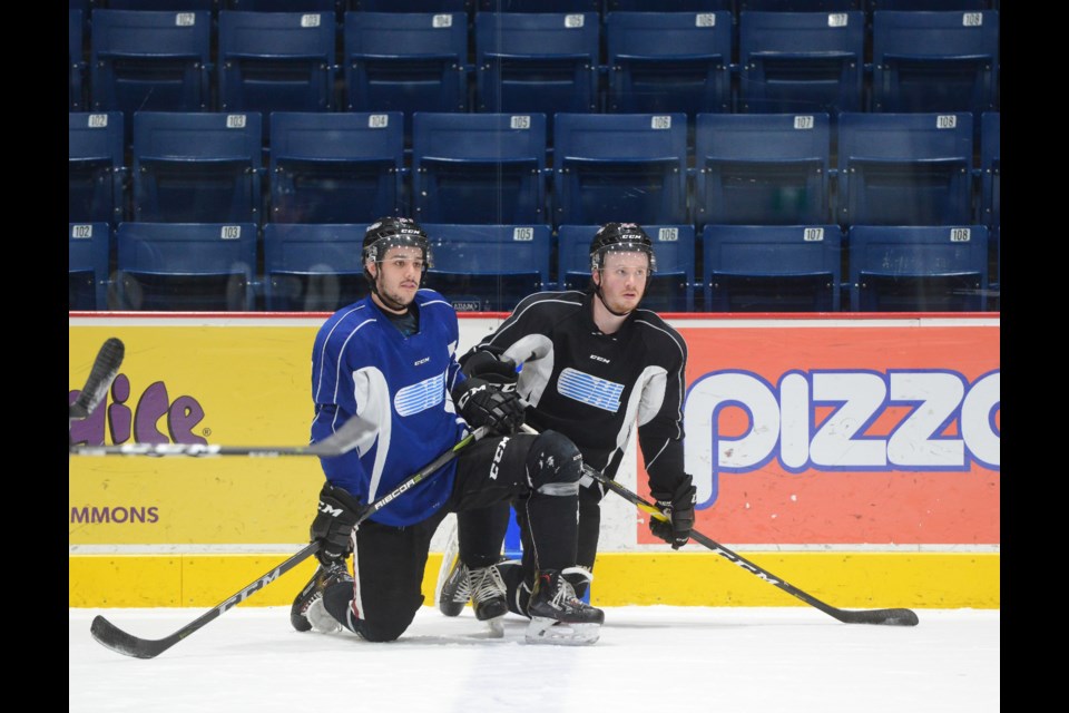Guelph Storm players Dom Commisso, left, and Jack Hanley take a breather at practice Wednesday. Tony Saxon/GuelphToday