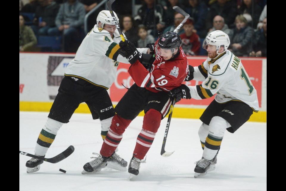 Isaac Ratcliffe of the Guelph Storm is sandwiched between London Knights Will Lochead, left, and Kevin Hancock Monday at the Sleeman Centre. Tony Saxon/GuelphToday