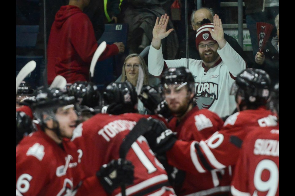 The Guelph Storm, and a fan, celebrate their Game 6 win at the Sleeman Centre Saturday night. Tony Saxon/GuelphToday