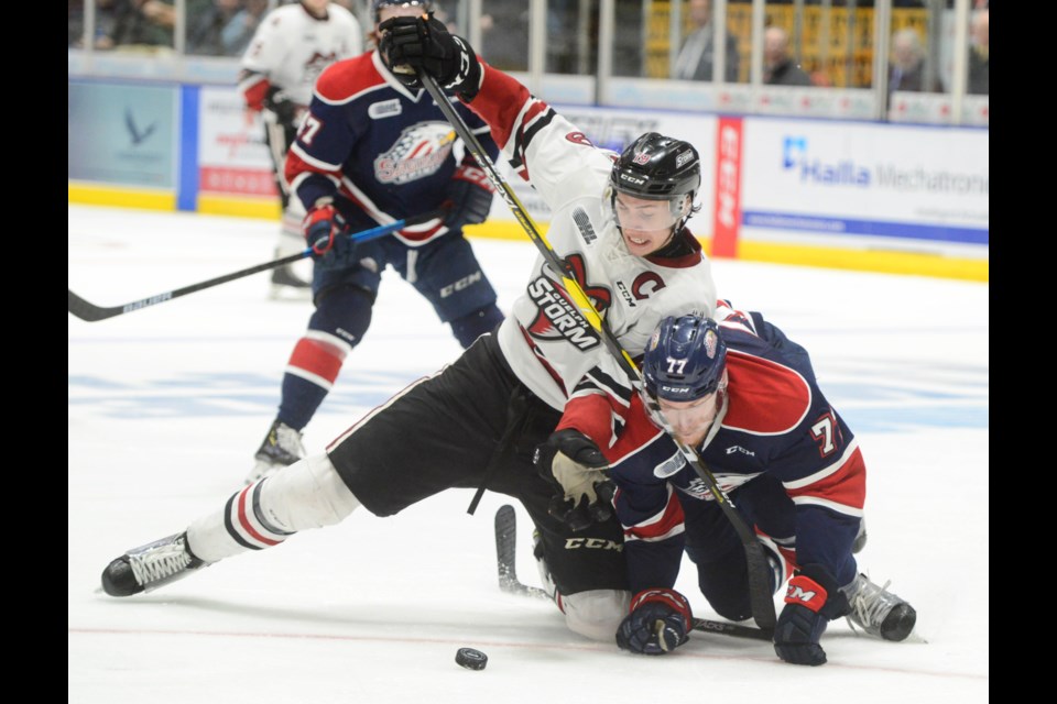 The Guelph Storm's Isaac Ratcliffe battles for the puck with Saginaw's Reilly Webb. Tony Saxon/GuelphToday