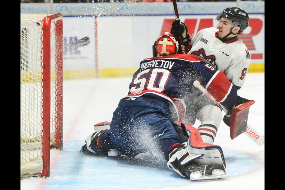 Nick Suzuki slides into Saginaw goaltender Ivan Prosvetov after being stopped on a breakaway in the first period Saturday in Saginaw. Tony Saxon/GuelphToday