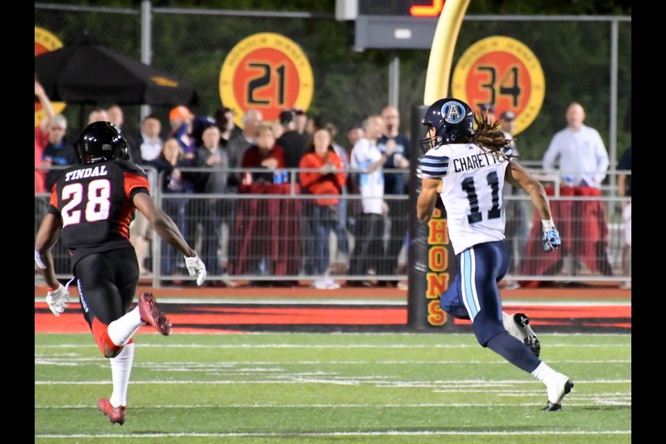 Former Guelph Gryphon Alex Charette (11) of the Toronto Argonauts runs away from Corey Tindal of the Ottawa RedBlacks during CFL preseason play Thursday at Alumni Stadium. Charette scored a touchdown on the play. Rob Massey for GuelphToday