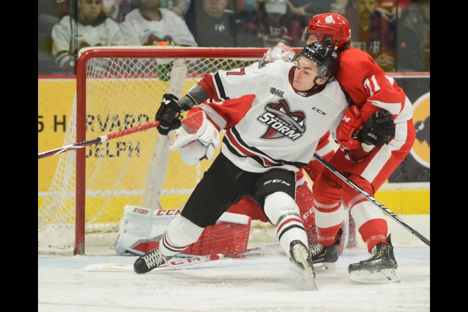 Guelph's Pavel Gogolev is tackled by Tanner Dickinson of the Soo Greyhounds as he cuts in front of the Guelph Storm net Friday night at the Sleeman Centre. Tony Saxon/GuelphToday