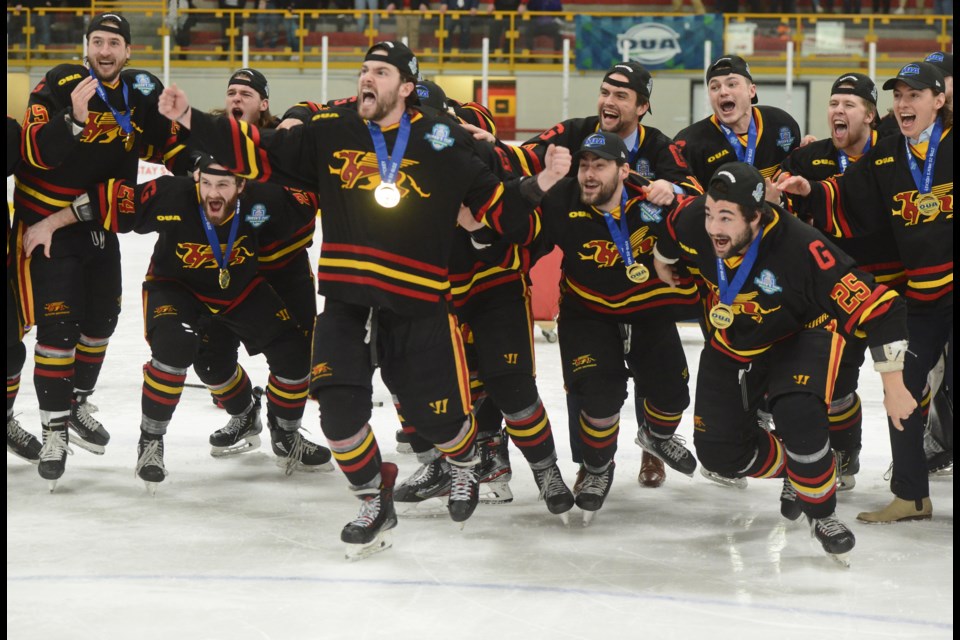 The Guelph Gryphons erupt as their captains bring over the Queen's Cup Saturday at the Gryphon Centre. Tony Saxon/GuelphToday