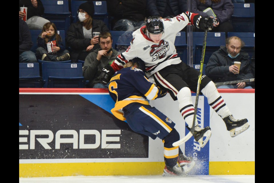 Guelph Storm defenceman Luka Profaca nails Erie Otters forward Taeo Artichuk along the boards Friday night at the Sleeman Centre.