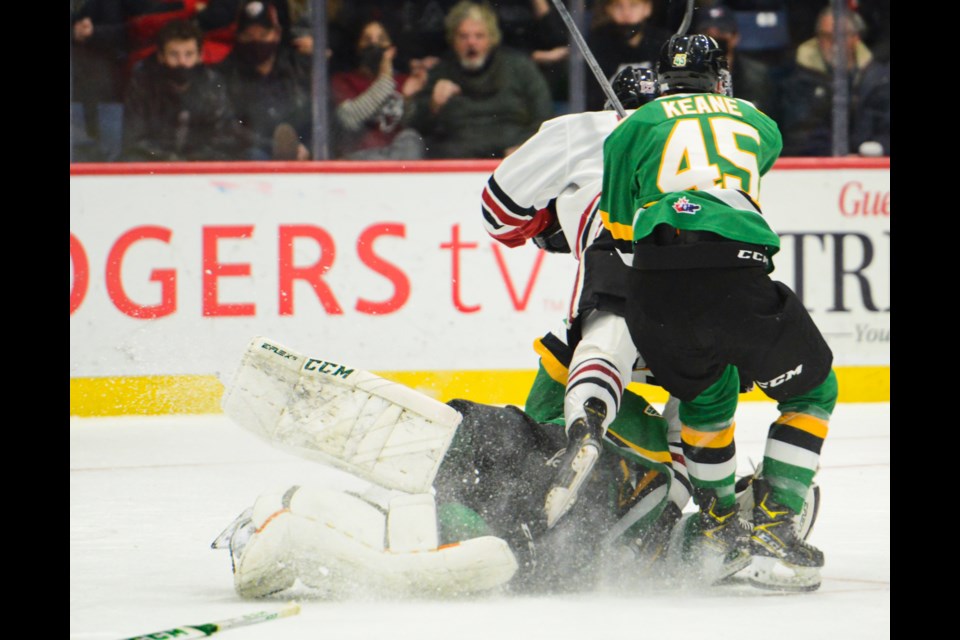 The Guelph Storm's Braeden Bowman is tripped by London Knights goaltender Brett Brochu Friday night at the Sleeman Centre. Brochu received a penalty on the play.