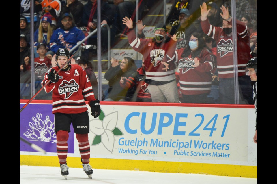 Cooper Walker points back to his teammates after scoring a first period goal Friday at the Sleeman Centre.