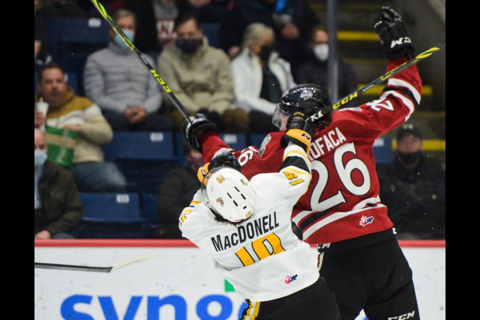Guelph's Luka Profaca rocks Sarnia's Angus MacDonell Friday at  the Sleeman Centre. Profaca was penalized on the play.