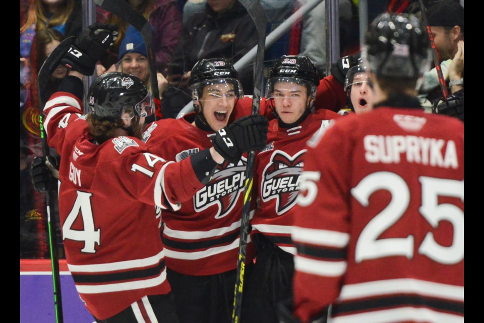 Guelph Storm players celebrate one of Cooper Walker's three goals Friday night at the Sleeman Centre.