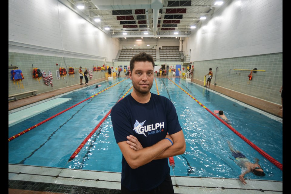 New Guelph Marlins coach Pavlo Illichov poses poolside at the University of Guelph.