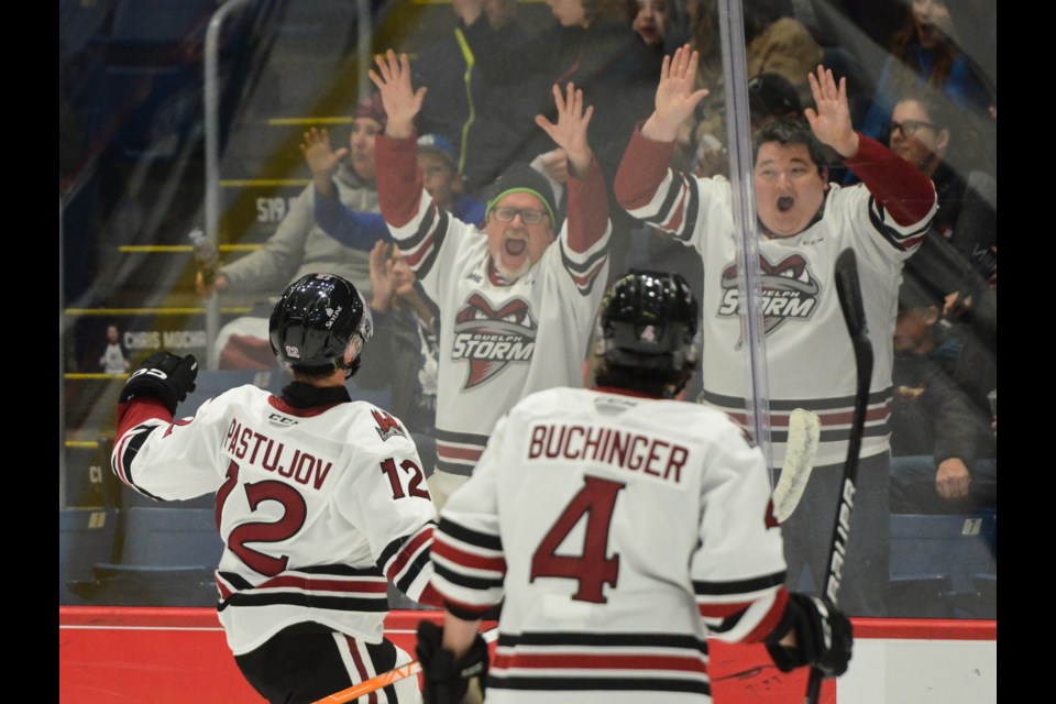 Sasha Pastujov of the Guelph Storm celebrates with some fans after scoring against the Flint Firebirds Friday night at the Sleeman Centre.