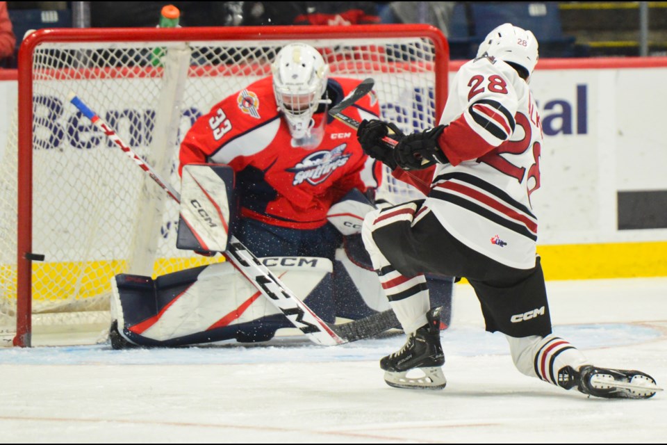 Cooper Walker of the Guelph Storm hits the post behind Windsor Spitfires goaltender Joey Costanzo in the first period Friday at the Sleeman Centre.