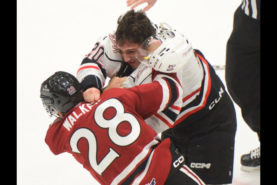 Guelph Storm's Cooper Walker and the Owen Sound Attack's Matt Papais fight at the end of the second period.