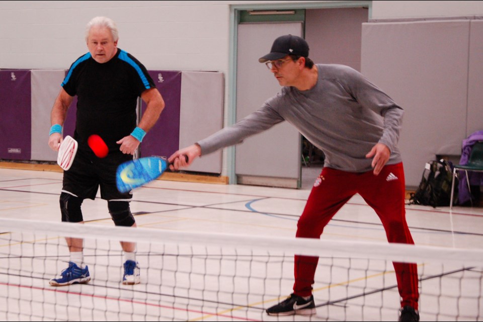 Mike Daly Sr., left, and Mike Daly Jr. took to a court during Guelph Pickleball Association action Saturday evening at Mitchell Woods Public School.