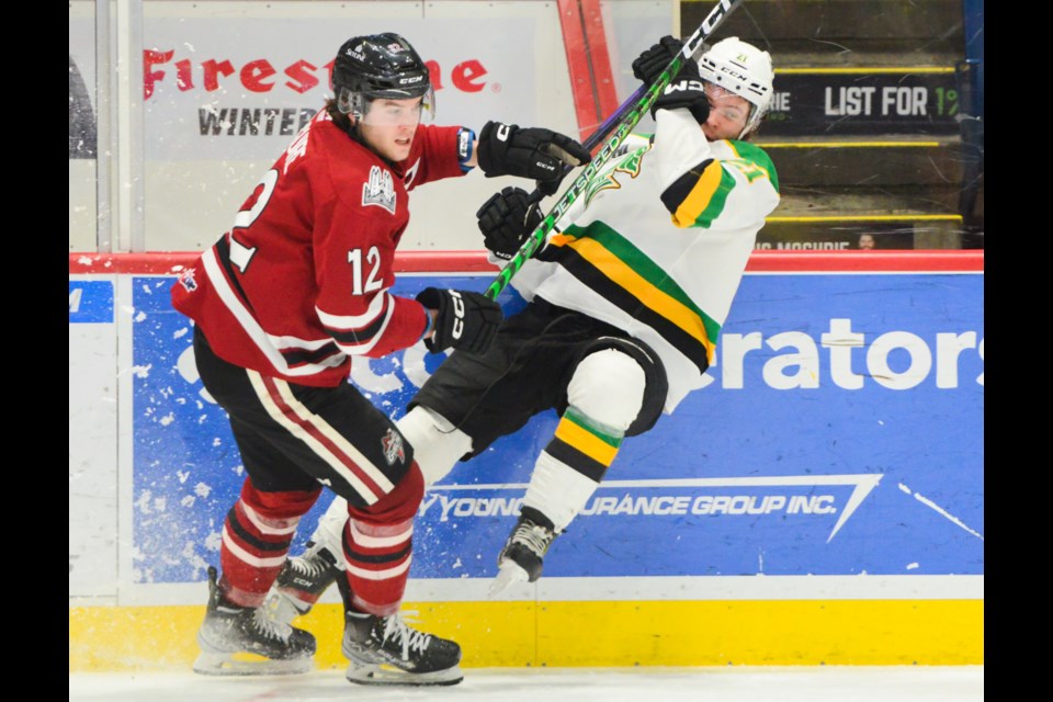 The Guelph Storm's Ryan McGuire knocks over the London Knights' Ryan Humphrey Wednesday at the Sleeman Centre.