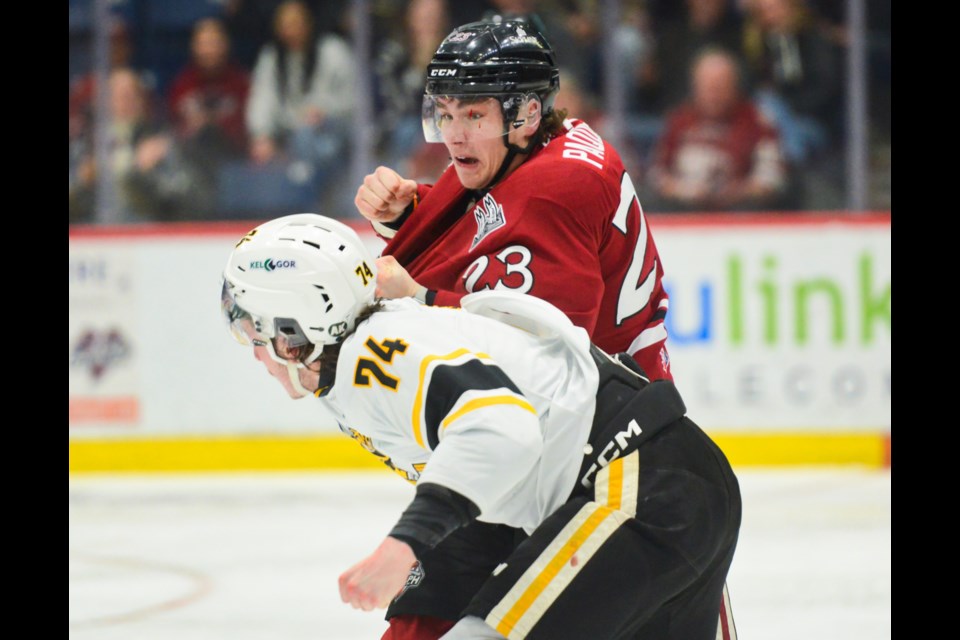 The Guelph Storm's Charlie Paquette fights the Sarnia Sting's Ethan Ritchie Thursday night at the Sleeman Centre.
