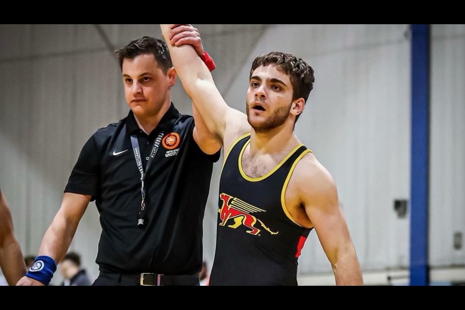 Guelph's Nathan Hunyady has his hand raised in victory at the 2023 Canadian Wrestling Championships. Hunyady took gold in the 65kg weight class in the junior division.