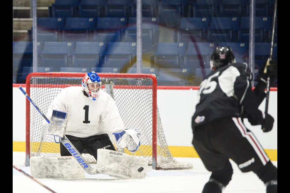 New Guelph Storm goaltender Damian Slavik makes a save on fellow import Vilmer Alriksson at training camp Tuesday.