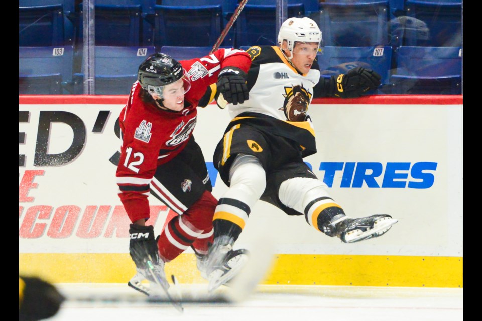 The Guelph Storm's Ryan McGuire hits a Brantford player in the corner during exhibition action at the Sleeman Centre Saturday.