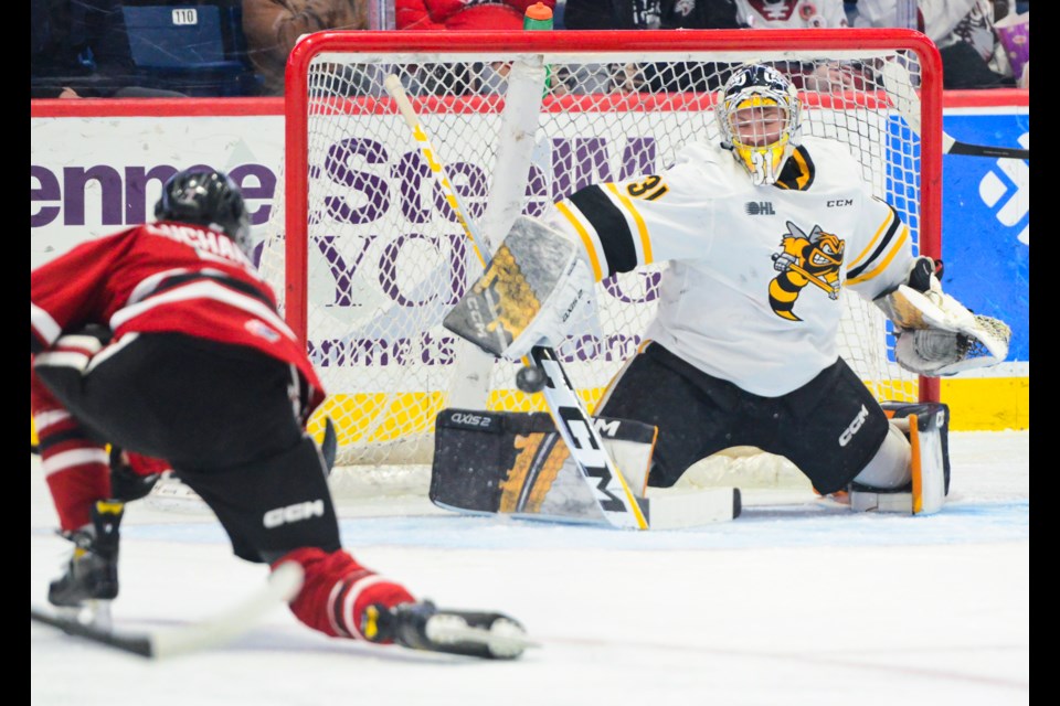 Sarnia Sting goaltender Nick Surzycia makes a great save on the Guelph Storm's Jett Luchanko Friday at the Sleeman Centre.