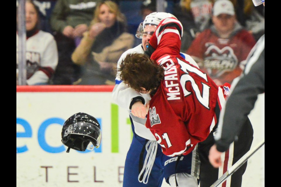 The Guelph Storm's Wil McFadden fights the Sudbury Wolves' Devin Mauro.