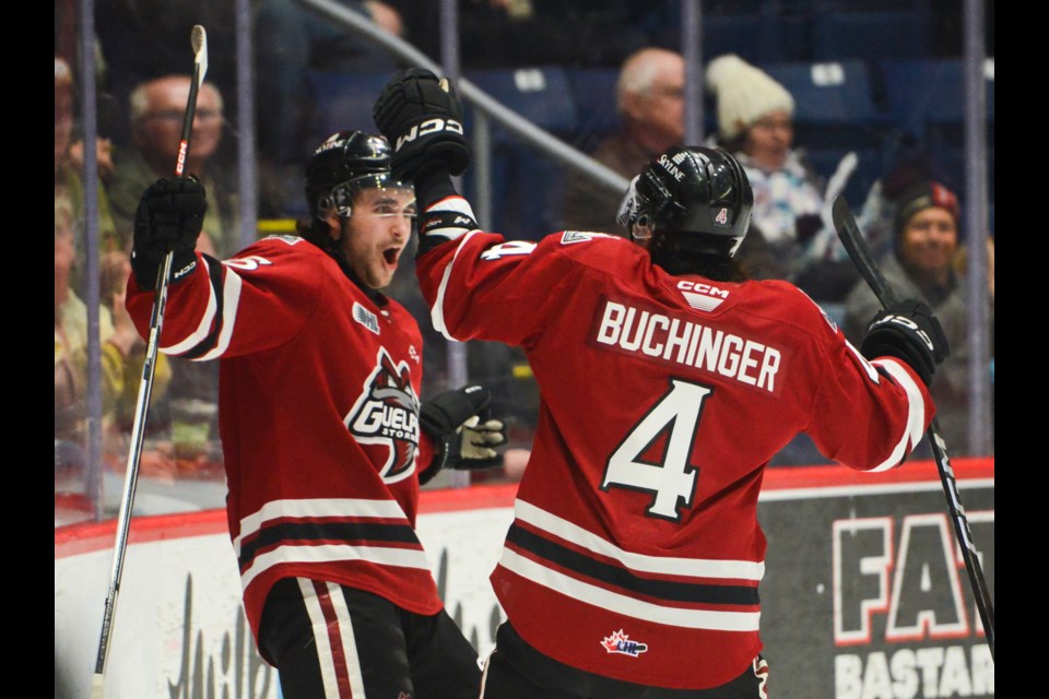 Gavin Grundner, left, celebrates his first period goal with teammate Michael Buchinger at the Sleeman Centre Thursday night.