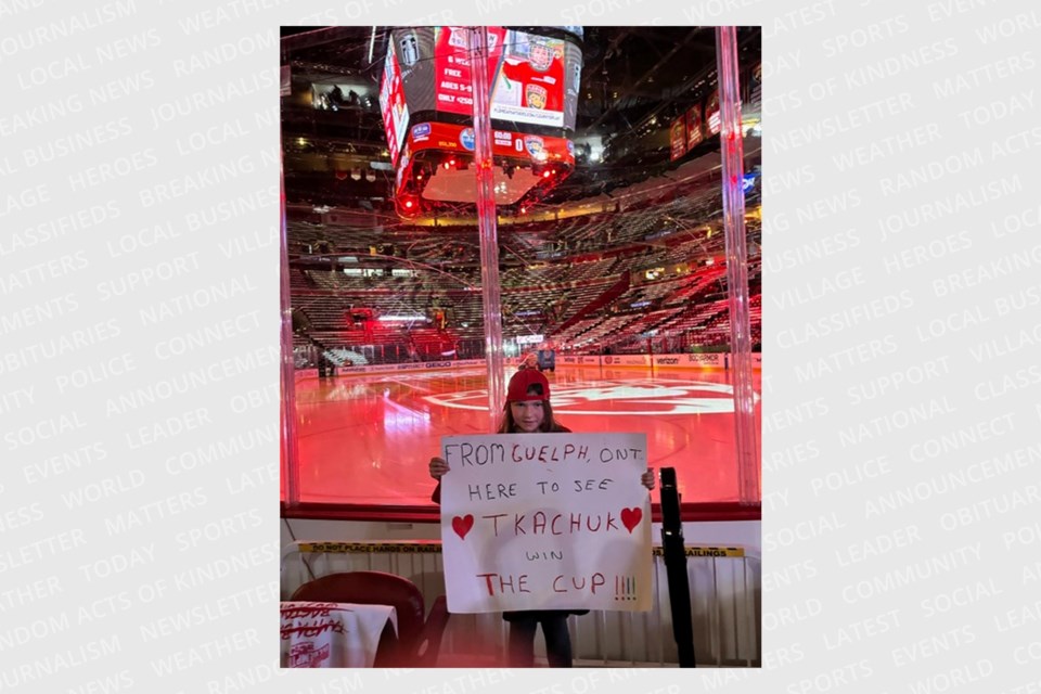 Ashley holds her sign inside Amerant Bank Arena