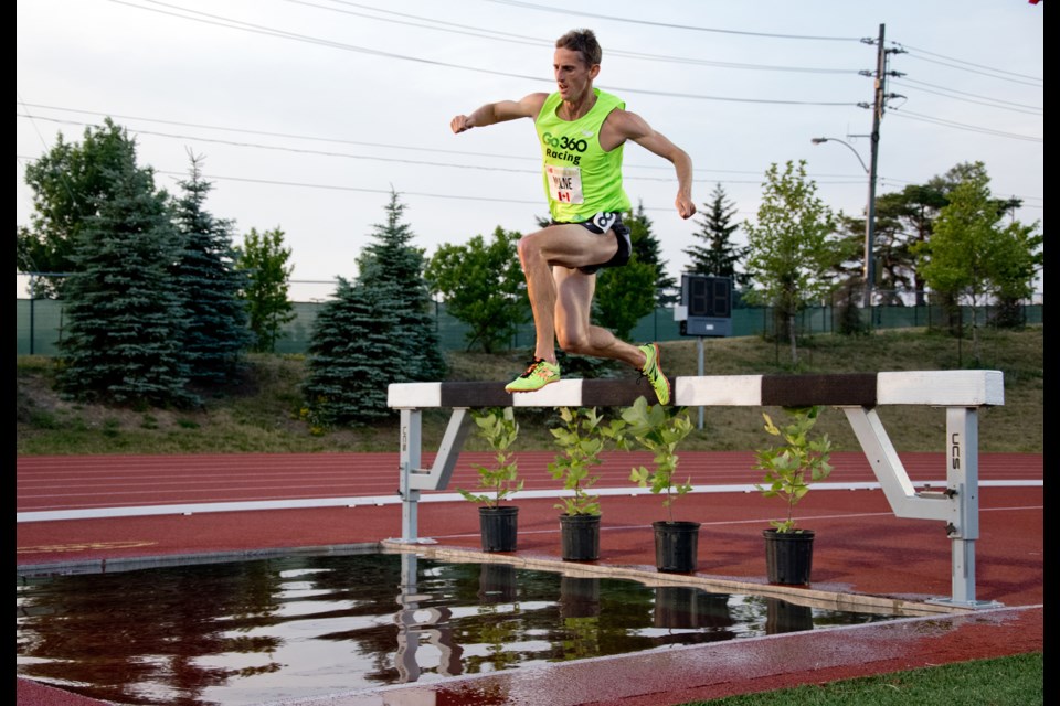 Taylor Milne of Guelph shoves off the hurdle at the water jump on his way to winning the New Balance men's 3,000-metre steeplechase at the Speed River New Balance Inferno track and field meet at Alumni Stadium. He won in 8:26.97, a meet record. Rob Massey for GuelphToday
