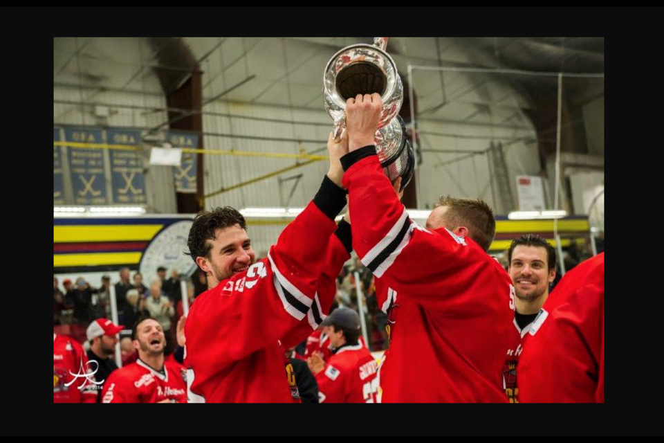 Justin Davis, left, celebrates a senior championship with the Dundas Real McCoys.