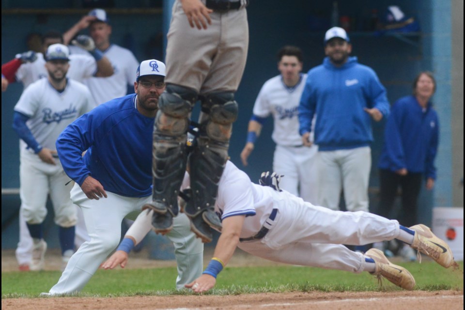Third base coach Justin Interisano watches intently as Kyle Kush dives into home plate with the winning run Saturday against the Toronto Maple Leafs. Tony Saxon/GuelphToday
