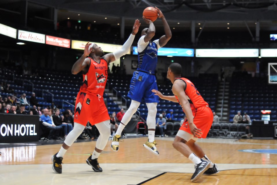 Olu Famutimi, middle, of the Guelph Nighthawks puts a shot up between the Fraser Valley Bandits pair of Jaylen Bland, left, and Grant Shepard during Saturday night's Canadian Elite Basketball League game at the Sleeman Centre. Rob Massey for GuelphToday
