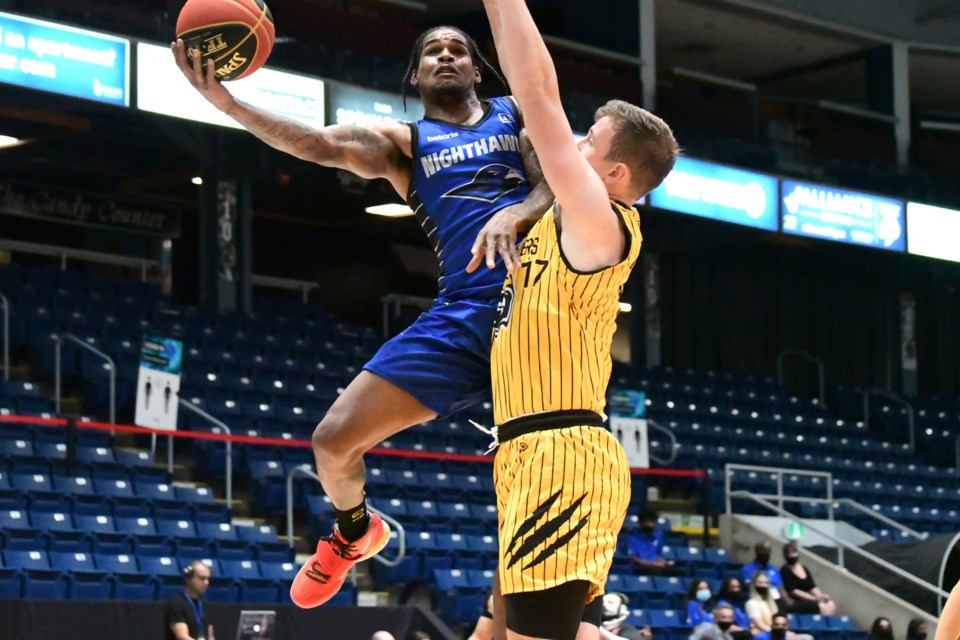 Ahmed Hill (left) of the Guelph Nighthawks tries to put a layup in around Thomas Kennedy (17) of the Hamilton Honey Badgers in Canadian Elite Basketball League play Friday night at the Sleeman Centre. The Nighthawks fell 85-76 in their home opener. Rob Massey for GuelphToday