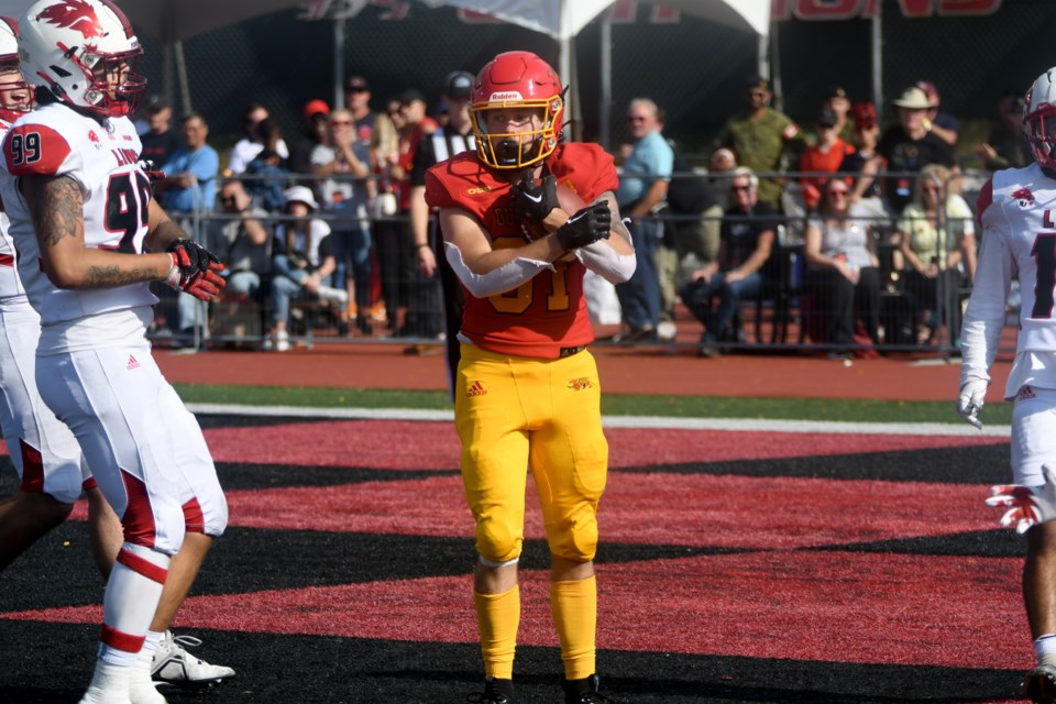 Jakub Tomas of the Guelph Gryphons holds on to the football after catching a three-yard touchdown toss from third-string quarterback Troy Hawkins. Tomas scored two touchdowns in an 88-7 win over the York Lions in Guelph's Homecoming Game Saturday at Alumni Stadium.
