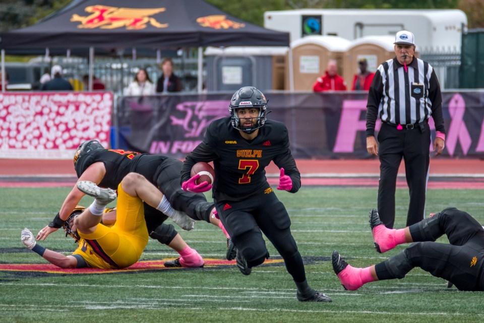 Kaine Stevenson (7) of the Guelph Gryphons carries the ball after a catch during Saturday's OUA football game against the Queen's Gaels at Alumni Stadium. One of the Gryphon seniors honoured before the game, Stevenson scored a touchdown in the 24-17 loss.