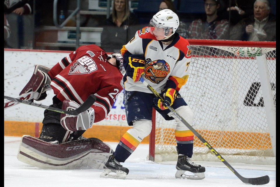 Guelph Storm goaltender Bradley Van Schubert reacts after being clipped by the  Erie Otters Christian Girhiny Friday at the Sleeman Centre. Tony Saxon/GuelphToday