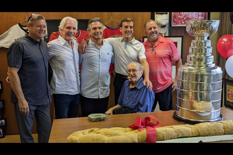 Joe Holody sits front and centre with his trademark cigar, as some old friends from the 1978 Centennial Cup champion Guelph Platers reunite with the Stanley Cup and a loaf of bread.