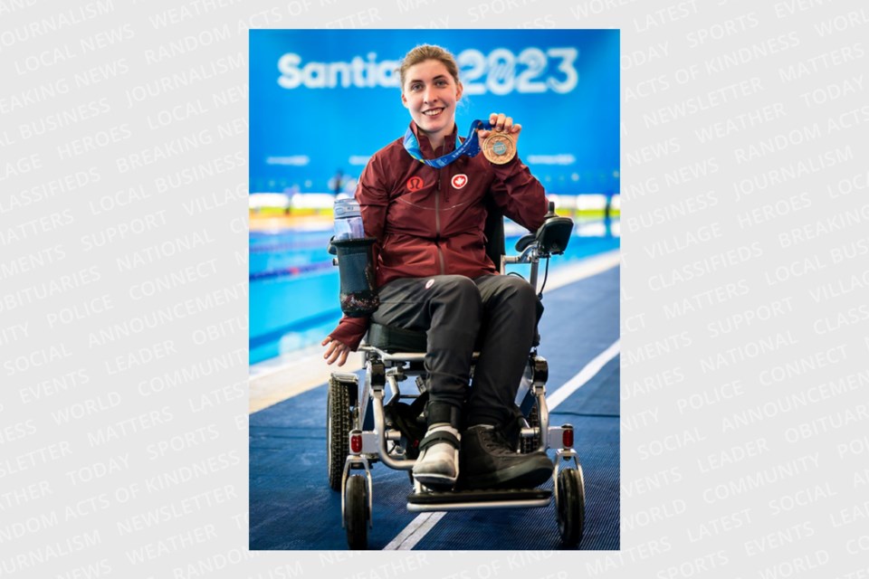 Guelph native Jordan Tucker holds up the bronze medal she won in the women's 50 metre butterfly S5 event at the Parapan Am Games in Santiago, Chile.
