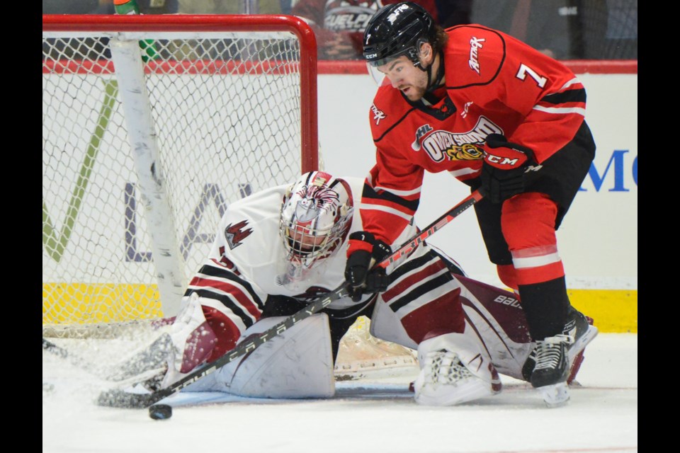 Owen Sound Attack's Denis Goure tries to corral a loose puck after a save by Guelph Storm netminder Brayden Gillespie Friday night at the Sleeman Centre.