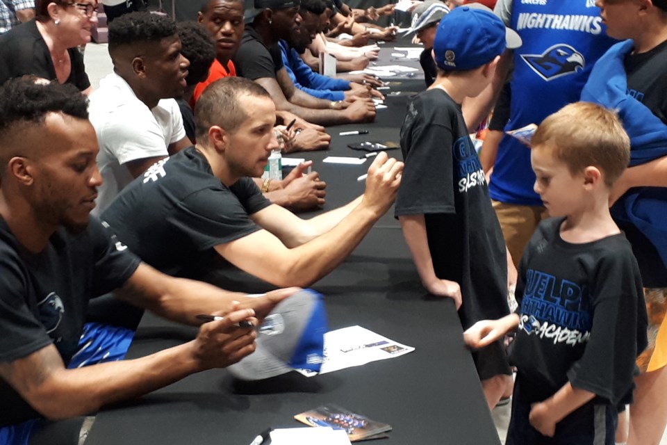Guelph Nighthawks players sign autographs for fans following a Canadian Elite Basketball League game at the Sleeman Centre. Rob Massey for GuelphToday