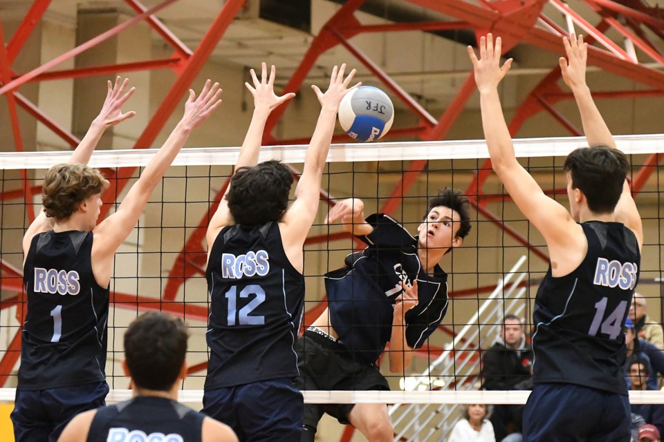 Alex Dorling (17) of the Bishop Macdonell Celtics tries to hit the ball between blockers Aidan Nelson (1), Callum MacLeod (12) and Cole Miller (14) of the Ross Royals during Friday's District 10 high school senior boys' final. Ross won 3-0. Rob Massey for GuelphToday