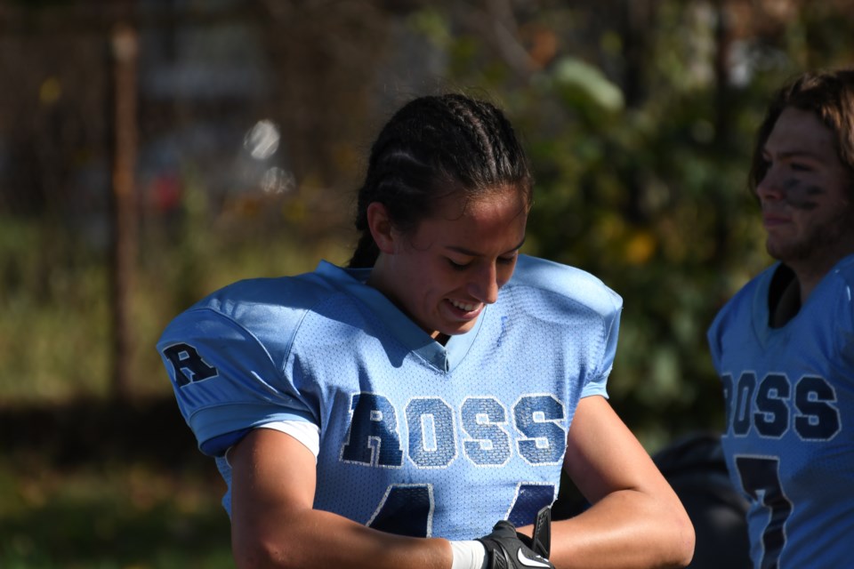 Olivia Sarabura of the Ross Royals tightens up her gloves as she gets set for her next series at linebacker during District 10 high school football play this season. Rob Massey for GuelphToday