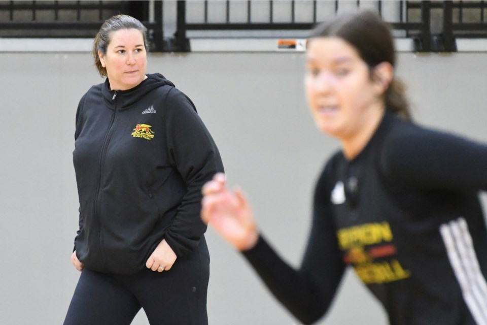Guelph Gryphons assistant coach Megan Reid keeps her eye on practice as player Sarah Holmes runs by during a recent session at the Guelph Gryphons Athletic Centre. Rob Massey for GuelphToday