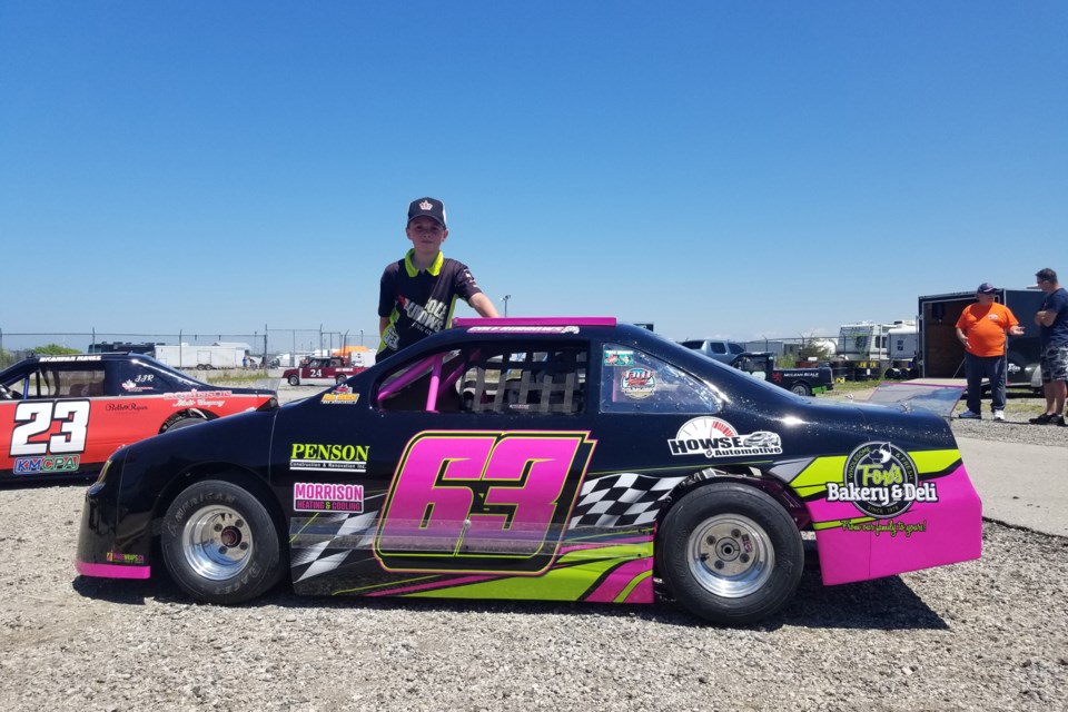 Guelph's Cole Burrows, 11, poses with the car he races in Junior Late Model races at Full Throttle International Speedway near Varney and Grand Bend International Speedway. Submitted Photo